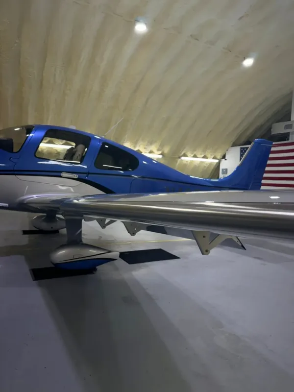 Blue and white single engine plane in a Houma hangar after exterior aircraft cleaning