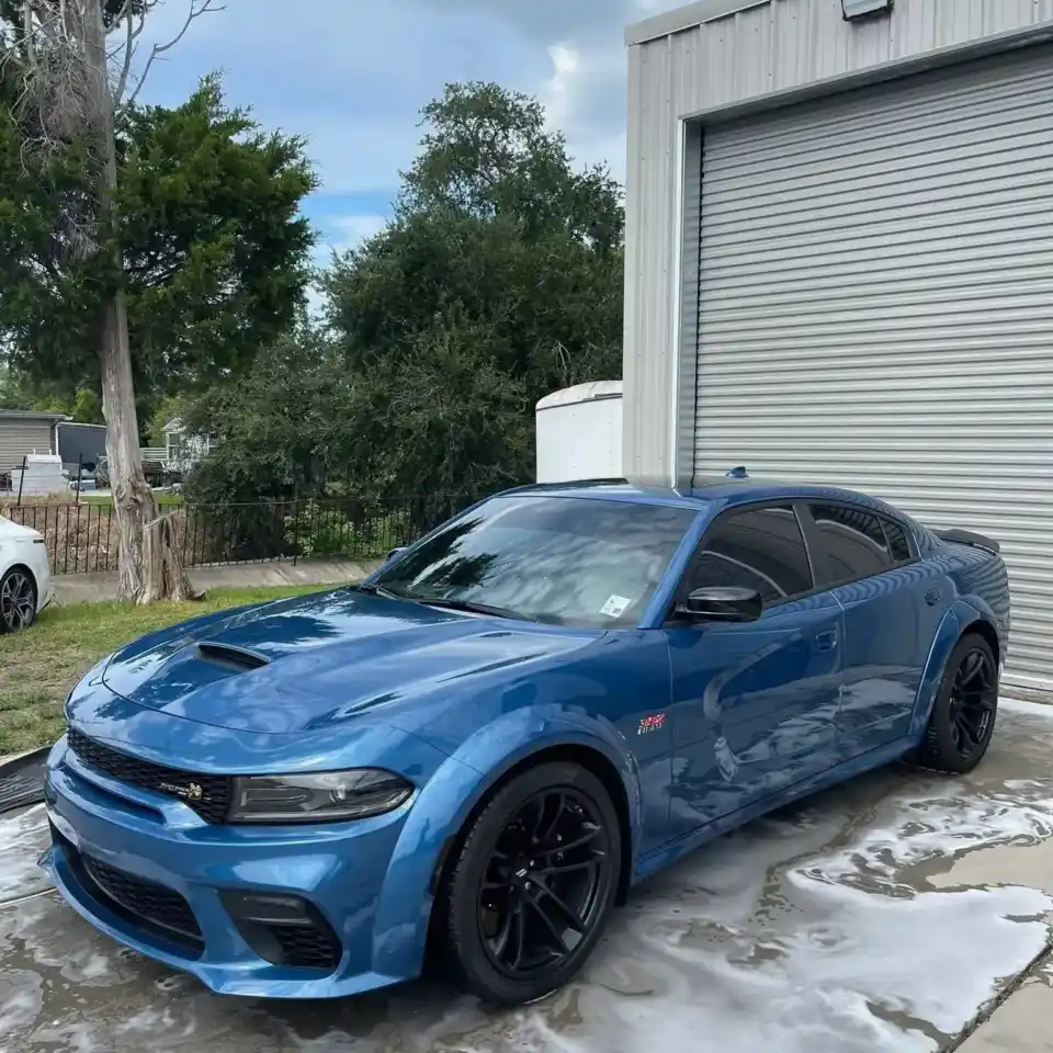 Blue Dodge Charger covered in foam during a hand wash at South Side Detail And Tint in Houma, LA