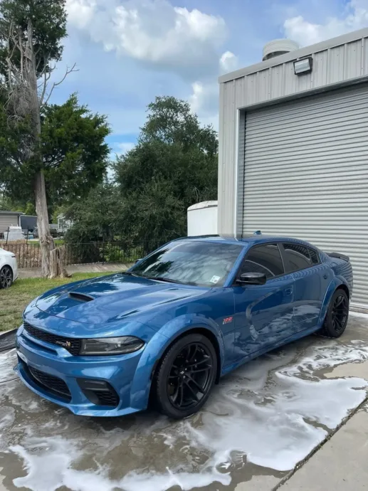 Blue Dodge Charger foam wash outside the Houma shop