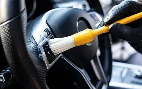 Car interior being cleaned during interior detailing at South Side Detail And Tint in Houma, LA