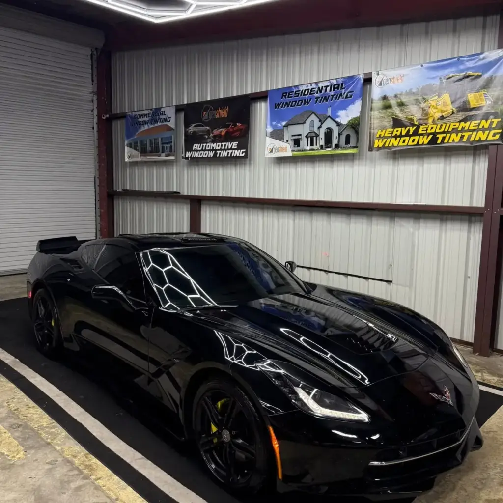 Black Corvette under hex shop lights at South Side Detail And Tint, professional window tinting in Houma, LA