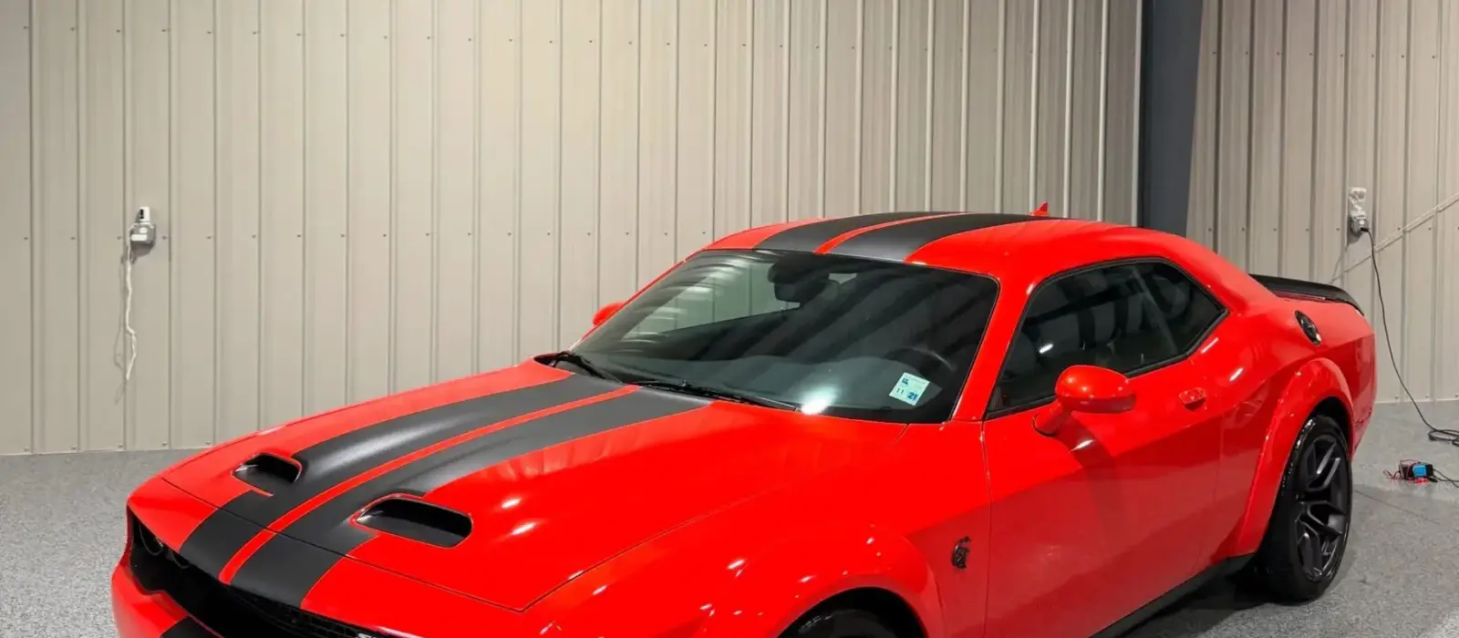Red Dodge Challenger at South Side Detail And Tint, ready for window tinting or detailing in Houma, LA