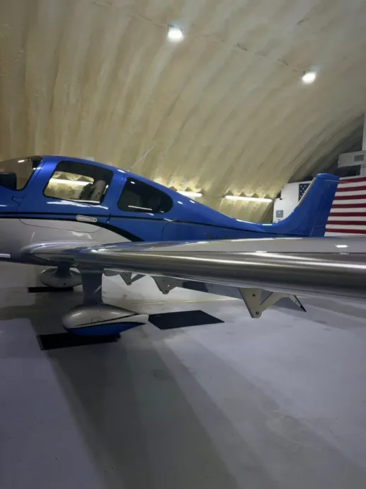 Blue and white single-engine plane in a hangar after detailing