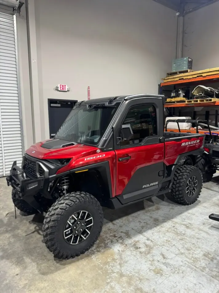 Red side-by-side inside the South Side Detail And Tint shop run by owner Nicholas Tabor in Houma, LA