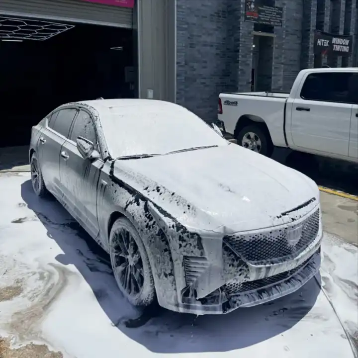 White sedan covered in foam during an auto detailing hand wash for a Bayou Cane customer