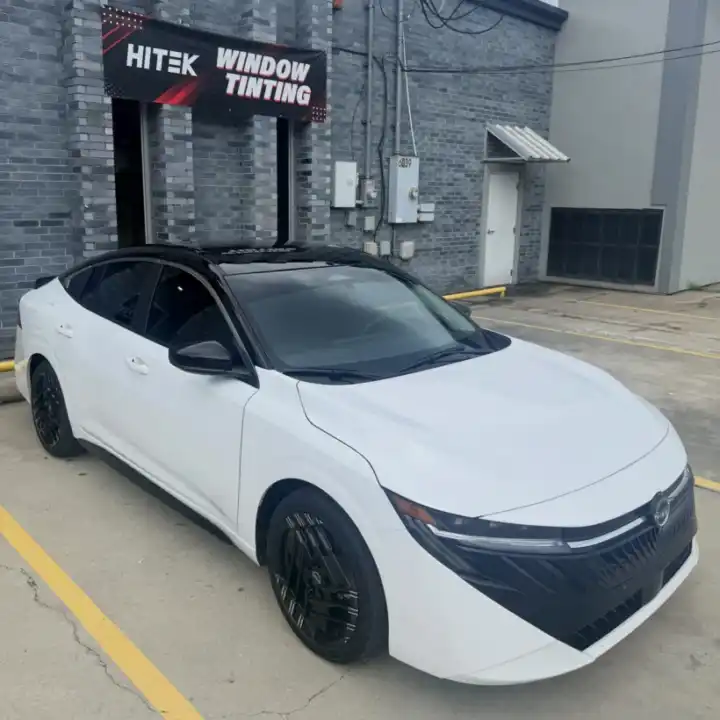White Toyota sedan with window tint under the HITEK Window Tinting sign at South Side Detail And Tint near Bayou Cane, LA