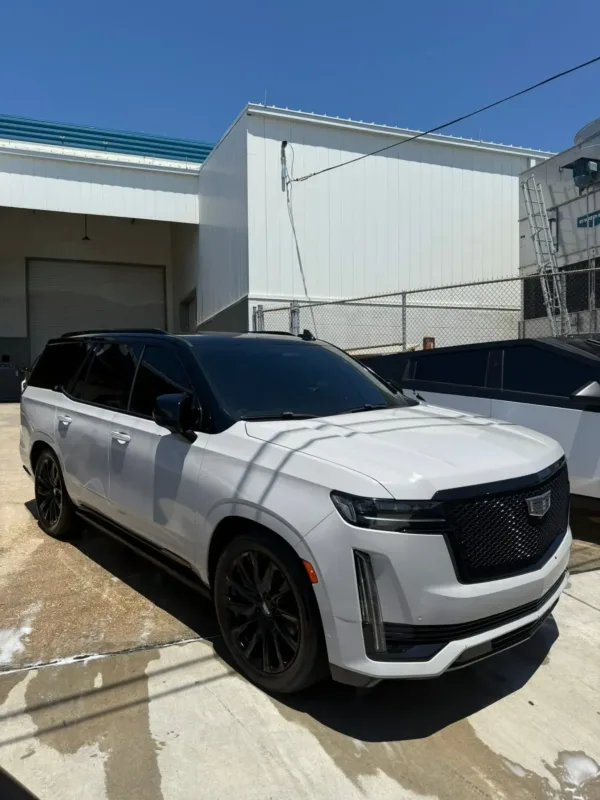 Cadillac Escalade with dark HITEK car window tinting installed at the South Side Detail And Tint shop in Houma, LA