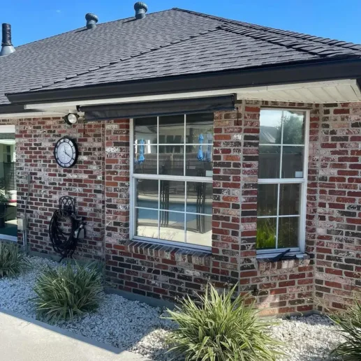Brick business building with commercial window film on street-facing windows in the Houma area