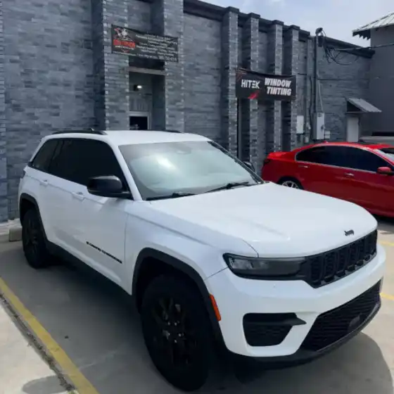 White Jeep Grand Cherokee with tinted windows at South Side Detail And Tint near Bayou Cane, LA