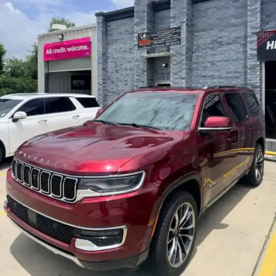 Red Jeep Wagoneer with tinted windows outside the South Side Detail And Tint shop, serving Bayou Cane, LA