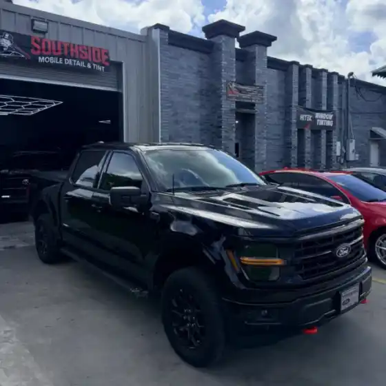Black pickup truck with tinted windows in front of the South Side Detail And Tint shop near Bayou Cane, LA