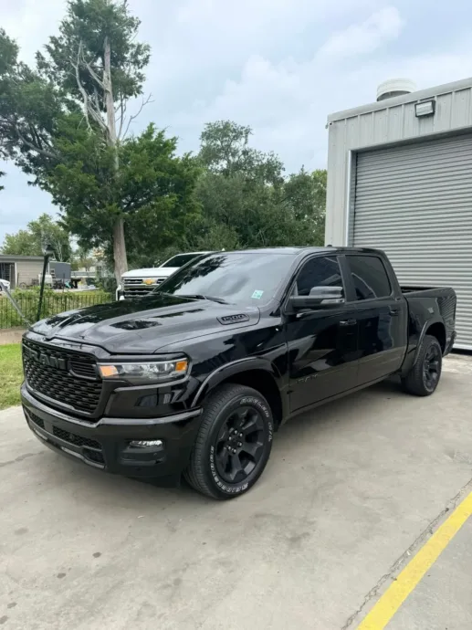 Black pickup truck with tinted windows at the South Side Detail And Tint shop, ready to quote by make and model in Houma, LA