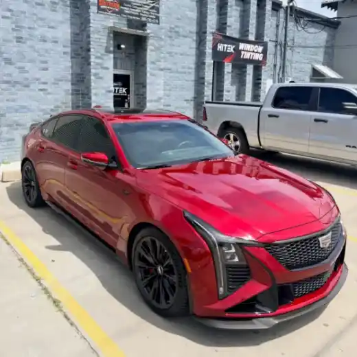 Red Cadillac sedan with tinted windows at South Side Detail And Tint in Houma, LA