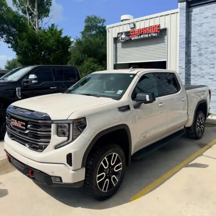 White GMC Sierra with tinted windows outside the South Side Detail And Tint shop, serving Bayou Cane, LA