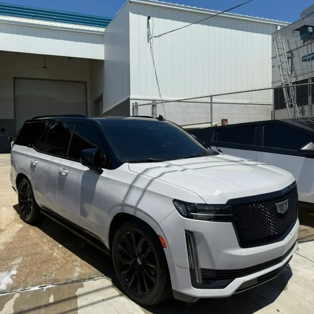 Cadillac Escalade with dark HITEK window tint at South Side Detail And Tint, answering window tinting and detailing FAQs in Houma, LA